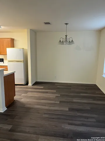 a view of a room with wooden floor and a cabinet