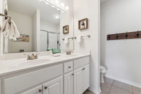 a bathroom with a glass shower door