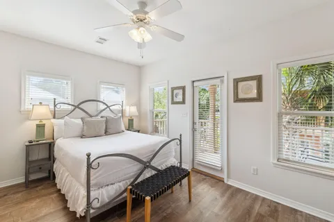 a bedroom with a bed a flat screen tv and a large window