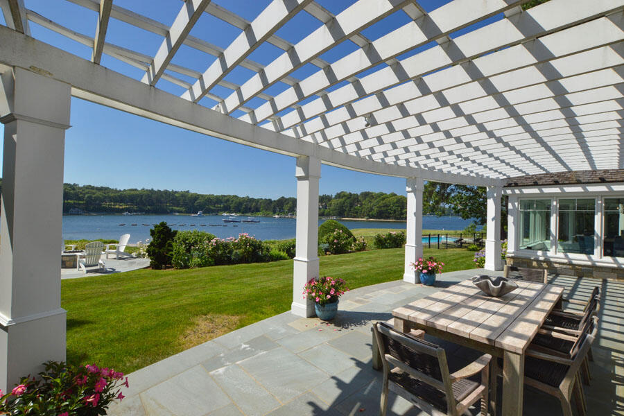 71 Sand Point Osterville, MA 02655 - Photo 5 of 45 a view of a patio with a table chairs and a backyard