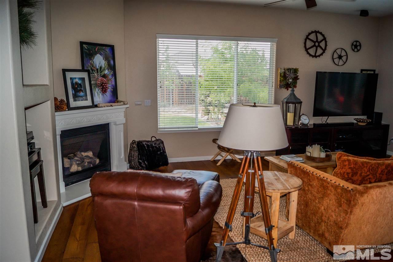 1725 Gold Belt Drive Reno, NV 89521 - Photo 8 of 23 a living room with furniture a flat screen tv and a fireplace