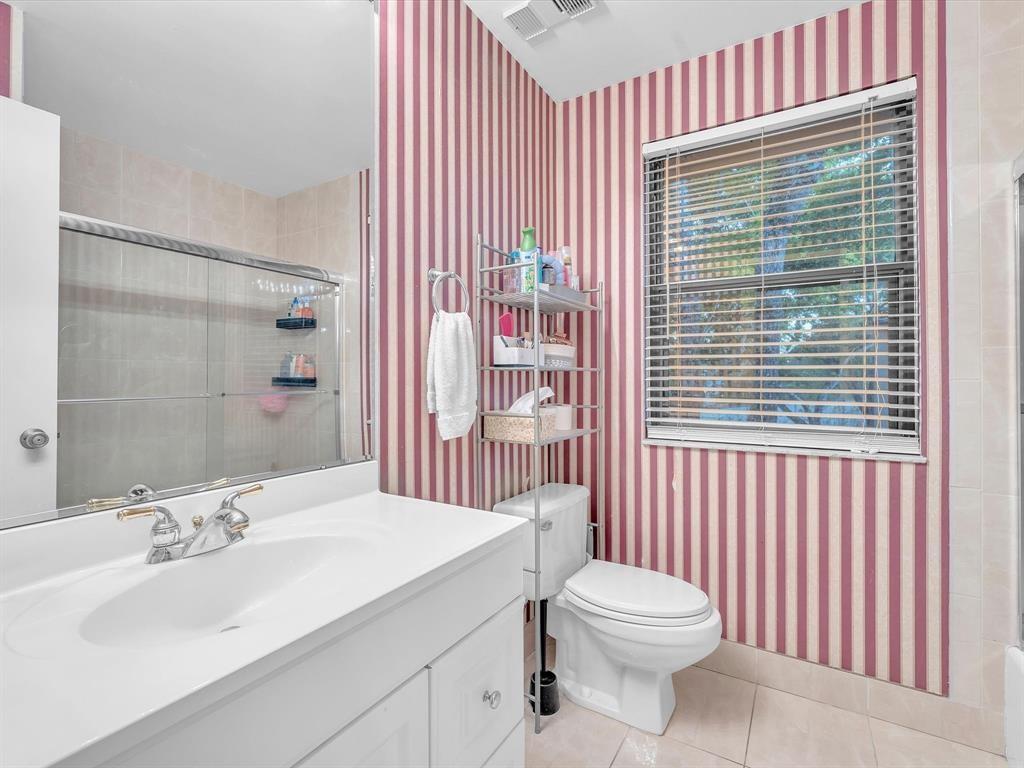 146 Northwest 98th Terrace, Unit 146 Plantation, FL 33324 - Photo 12 of 14 a bathroom with a sink a toilet and shower curtain