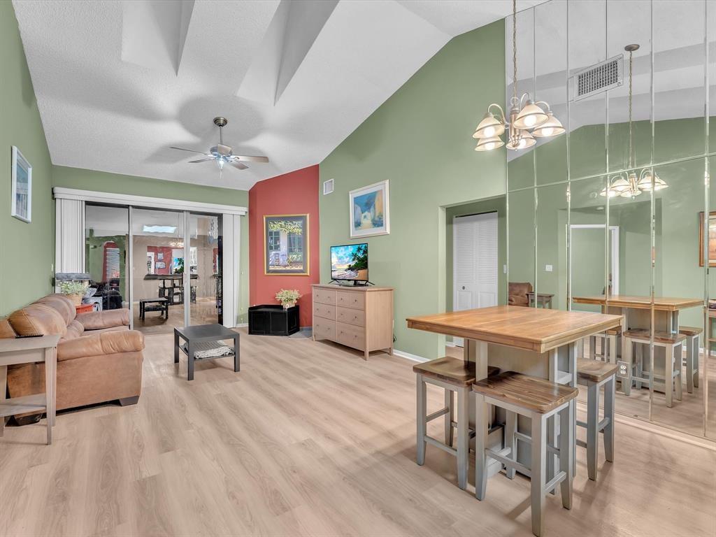 146 Northwest 98th Terrace, Unit 146 Plantation, FL 33324 - Photo 3 of 14 a view of a dining room with furniture and chandelier