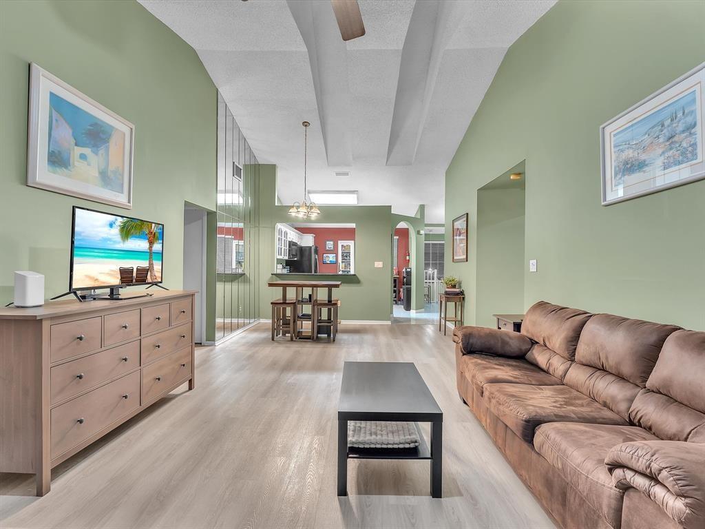 146 Northwest 98th Terrace, Unit 146 Plantation, FL 33324 - Photo 5 of 14 a living room with furniture and a flat screen tv
