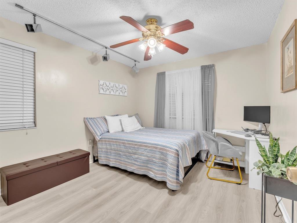 146 Northwest 98th Terrace, Unit 146 Plantation, FL 33324 - Photo 10 of 14 a bedroom with a bed and a chandelier