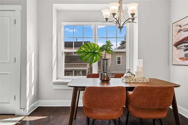 a view of a dining room with furniture and chandelier
