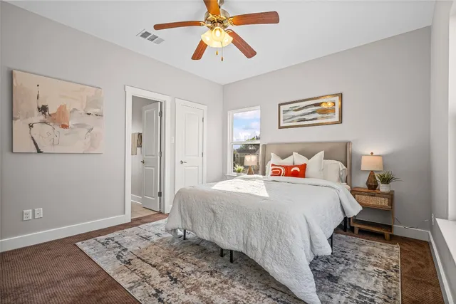 a bedroom with bed and wooden floor