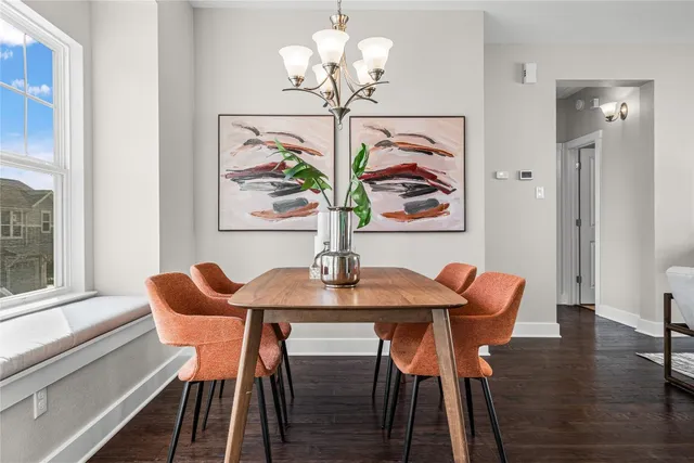 a view of a dining room with furniture wooden floor and a chandelier