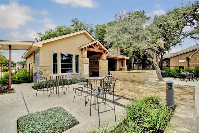 a front view of a house with a yard and potted plants