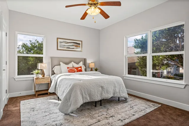 a bedroom with a large bed and a window