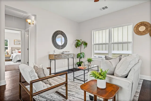 a living room with furniture and wooden floor