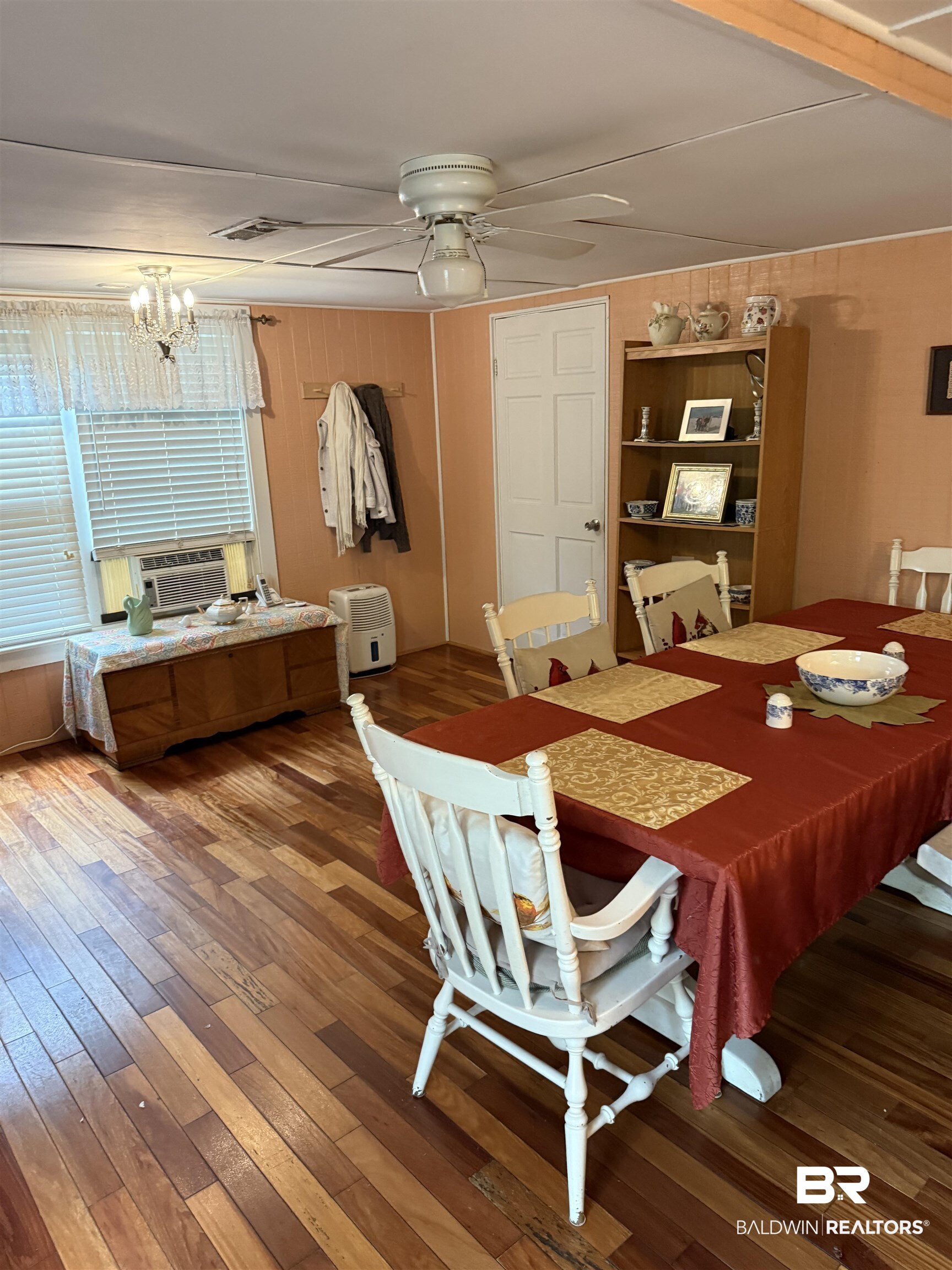 12990 Groves Road Summerdale, AL 36580 - Photo 3 of 8 Dining space with visible vents, cooling unit, hardwood / wood-style flooring, and ceiling fan with notable chandelier