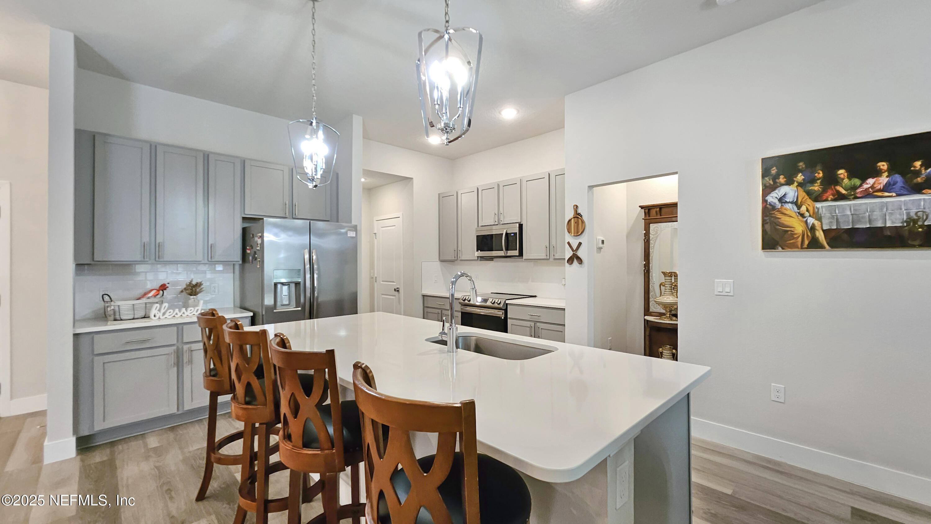 7 Smith Trail Palm Coast, FL 32164 - Photo 11 of 48 a kitchen with stainless steel appliances a dining table chairs and refrigerator