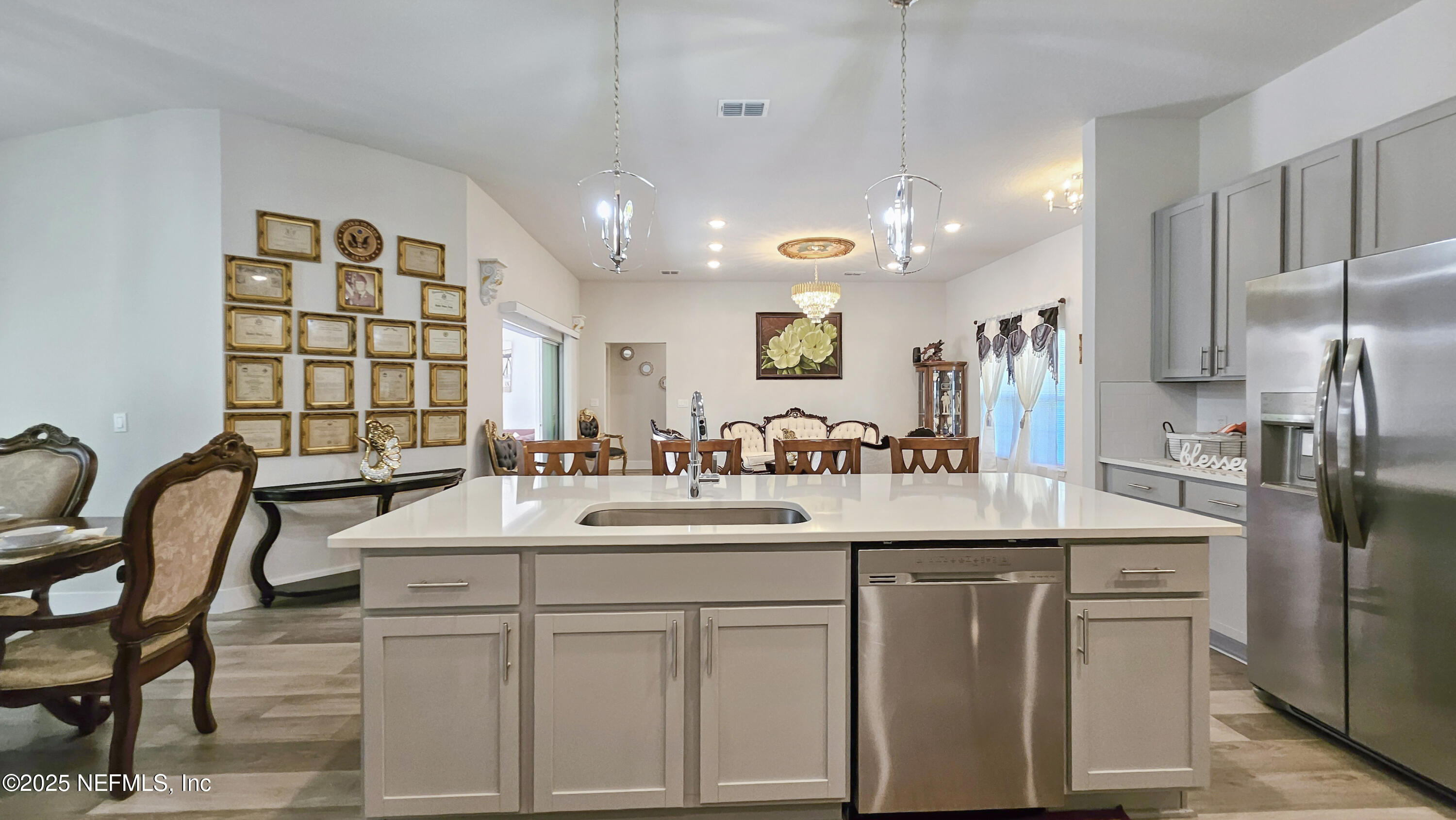 7 Smith Trail Palm Coast, FL 32164 - Photo 13 of 48 a kitchen with kitchen island granite countertop a sink and refrigerator