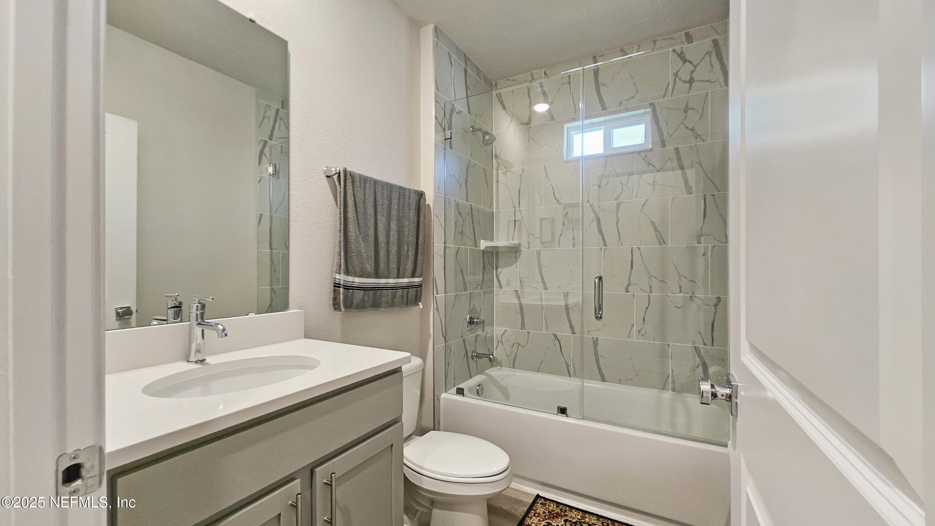 7 Smith Trail Palm Coast, FL 32164 - Photo 26 of 48 a bathroom with a granite countertop sink a toilet and shower
