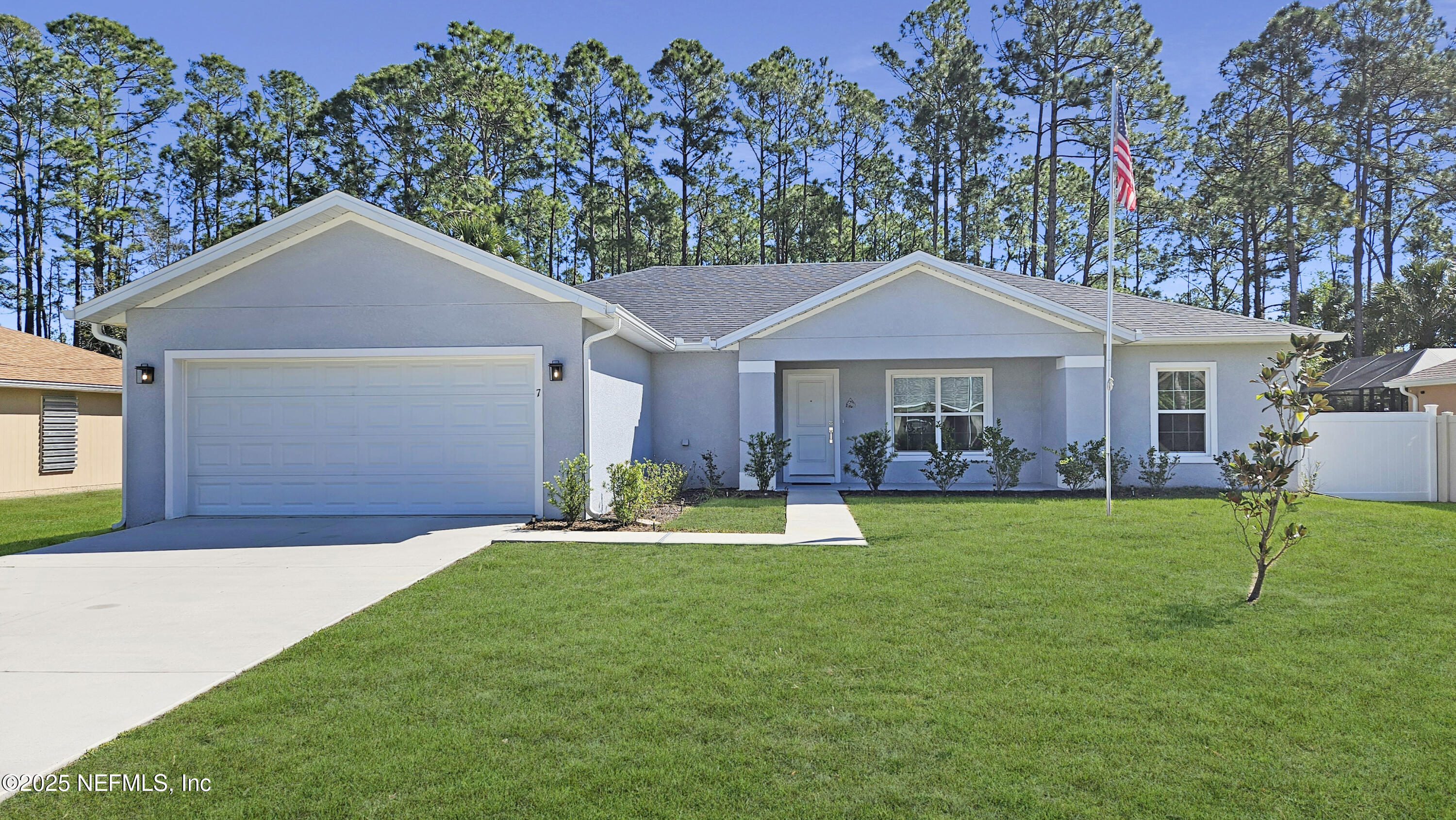 7 Smith Trail Palm Coast, FL 32164 - Photo 3 of 48 a front view of a house with a yard and trees