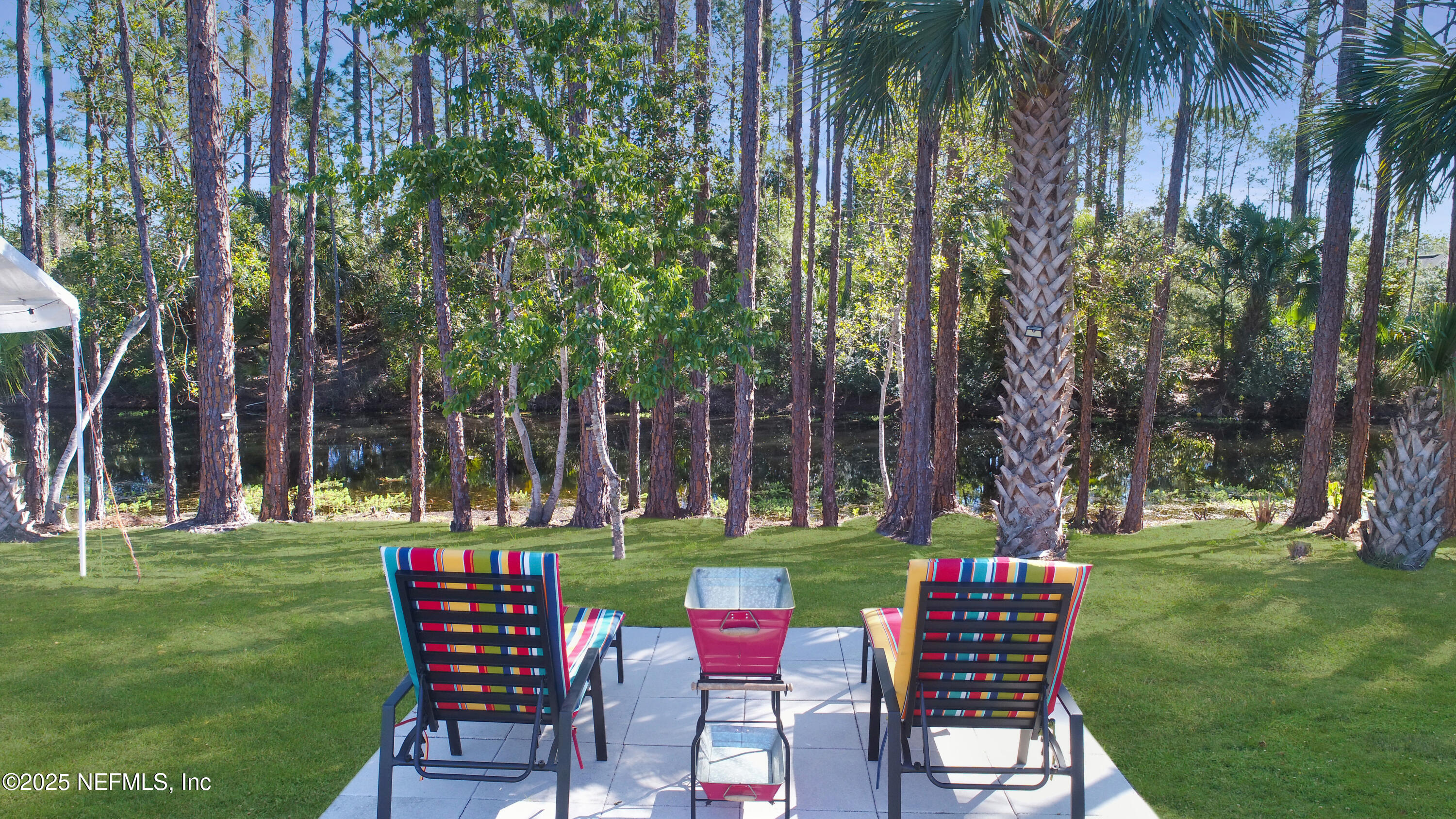 7 Smith Trail Palm Coast, FL 32164 - Photo 43 of 48 a backyard of a house with table and chairs