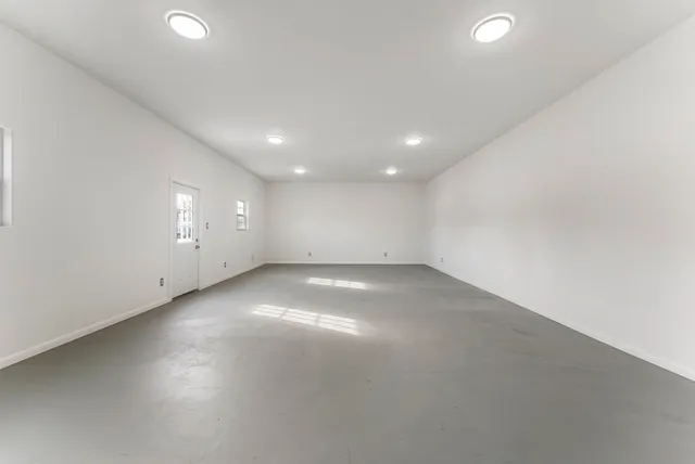 an empty room with a empty space and windows