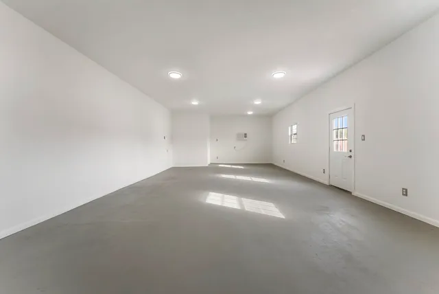 a bathroom with a toilet sink vanity and mirror