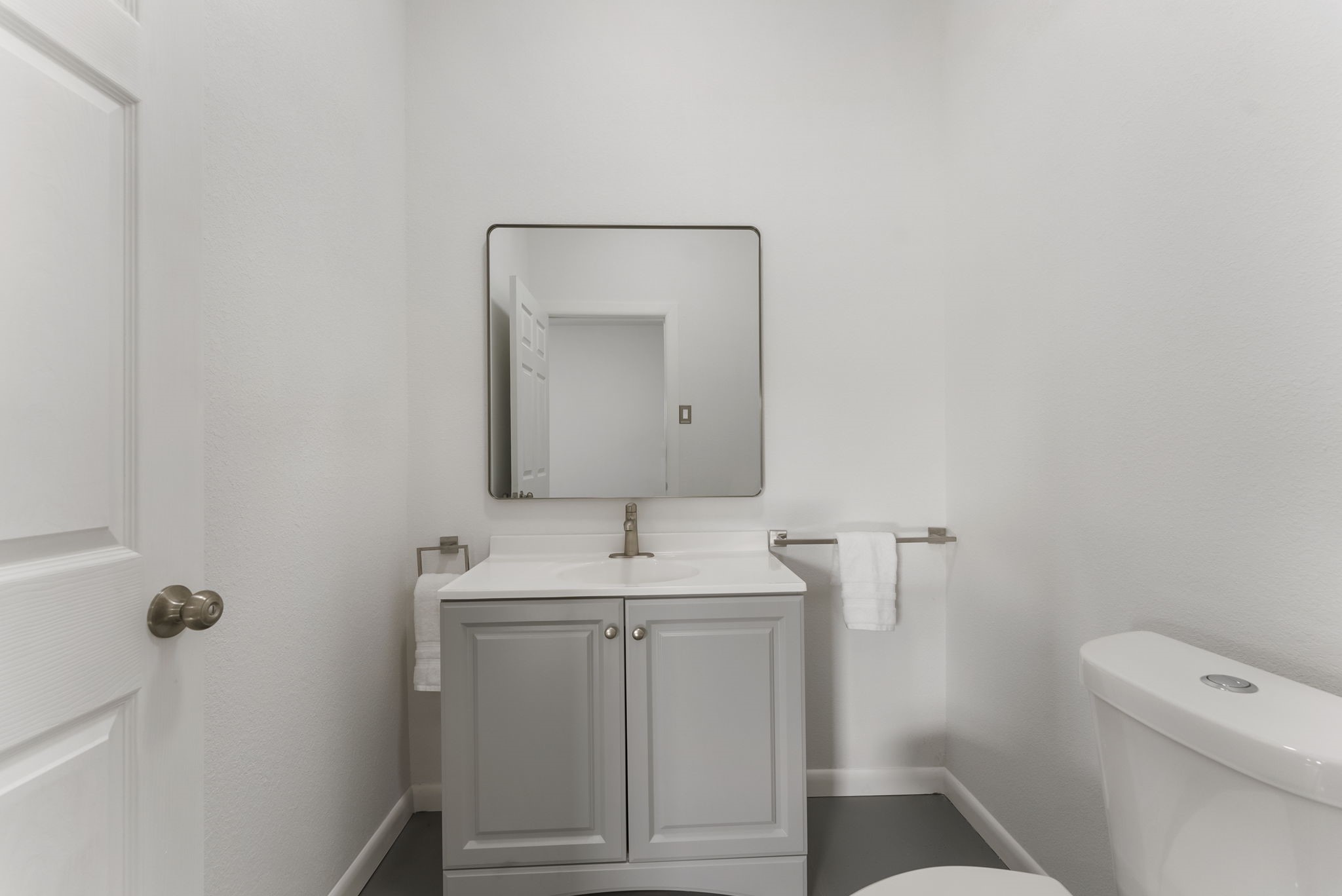 1635 Rayford Road Spring, TX 77386 - Photo 20 of 50 a bathroom with a toilet sink vanity and mirror