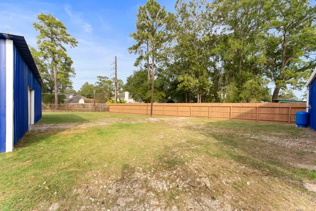 a view of backyard with trampoline