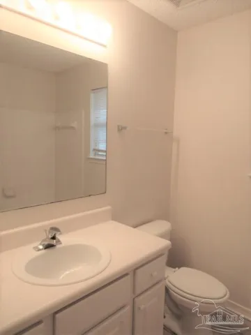 a bathroom with a sink a toilet and mirror