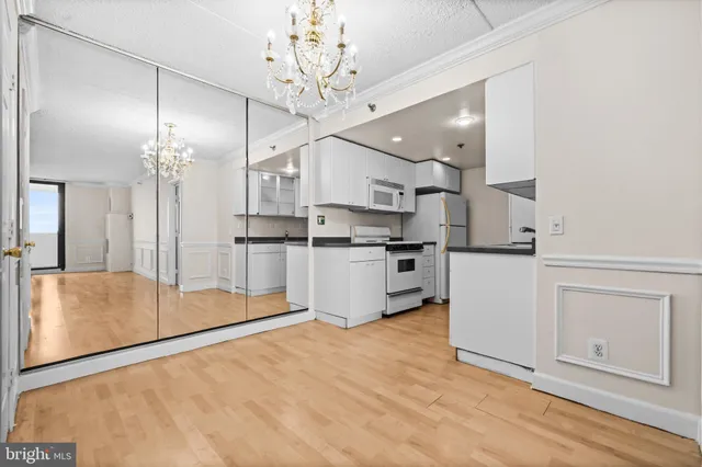 a kitchen with stainless steel appliances a refrigerator sink and cabinets