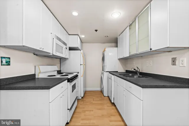 a kitchen with stainless steel appliances granite countertop a sink and a stove