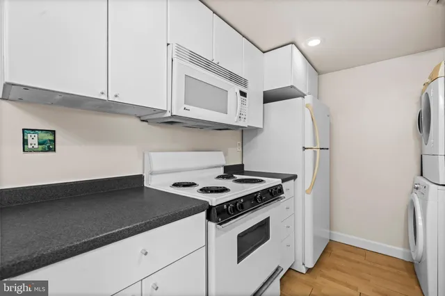 a kitchen with stainless steel appliances white cabinets and a stove