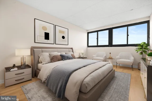 a bedroom with bed and a large window