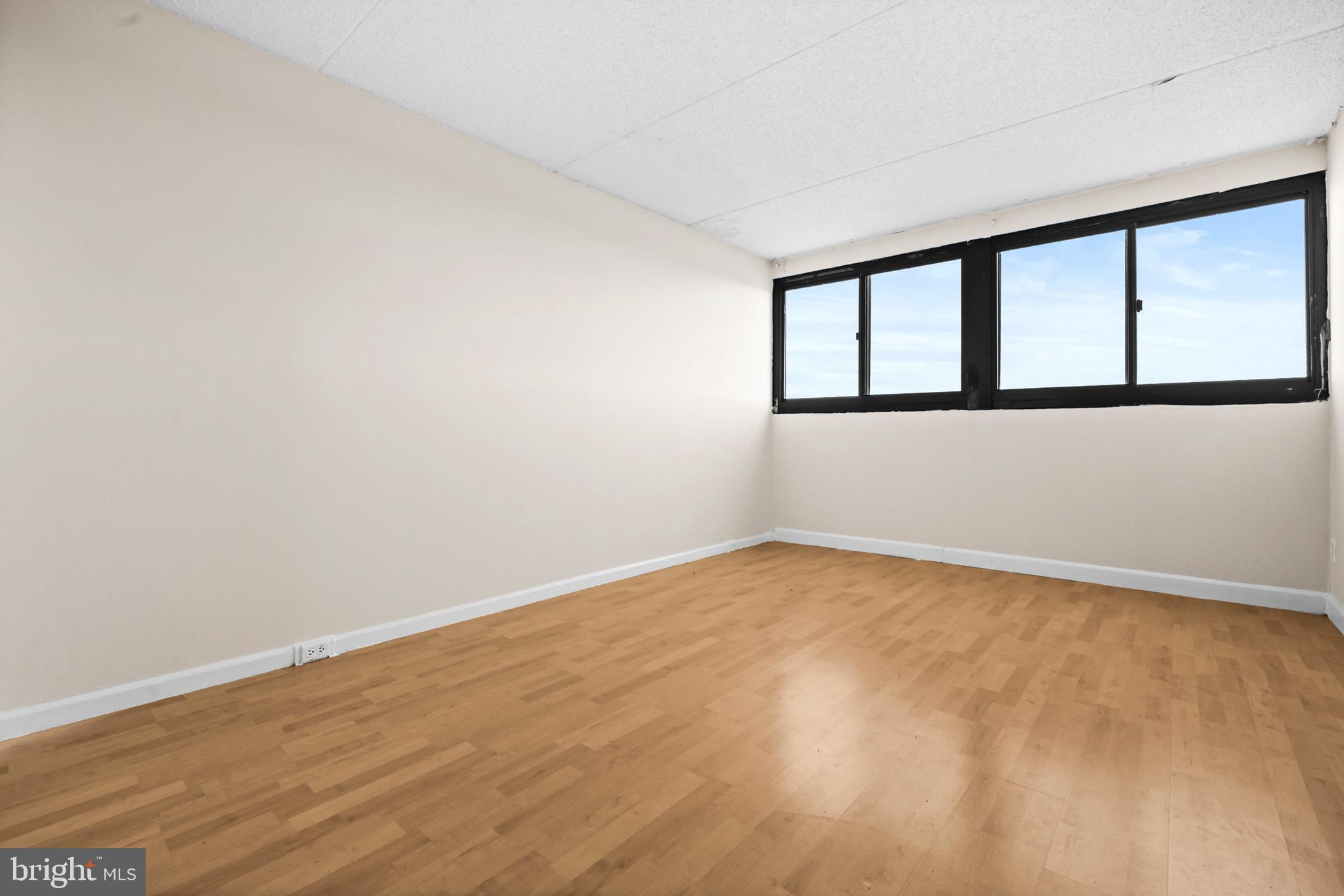 5911 Edsall Road, Unit 1209 Alexandria, VA 22304 - Photo 18 of 30 a view of an empty room with wooden floor and a window