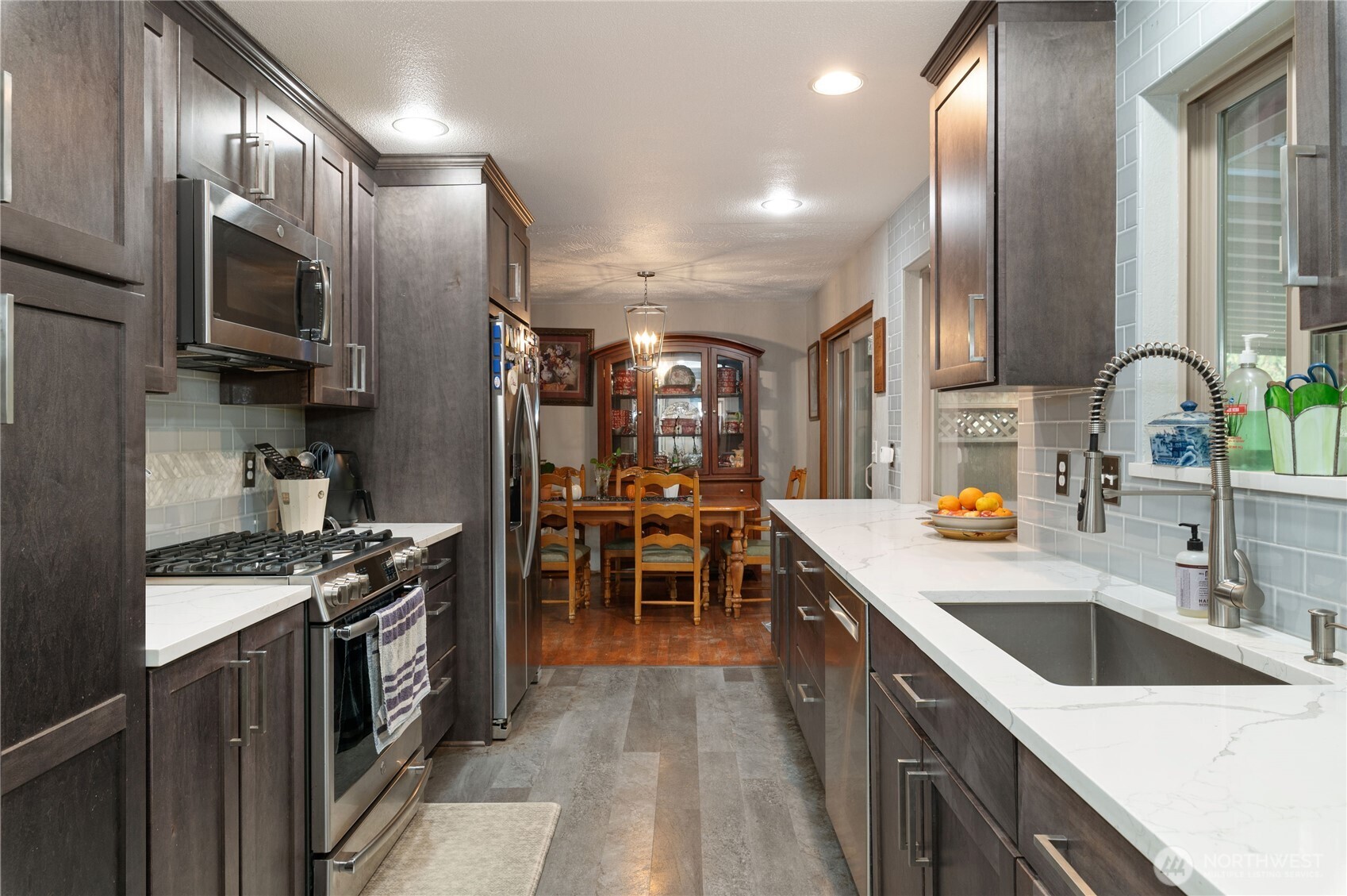 9101 112th Street Southwest Lakewood, WA 98498 - Photo 17 of 27 a kitchen with stainless steel appliances a sink stove and cabinets