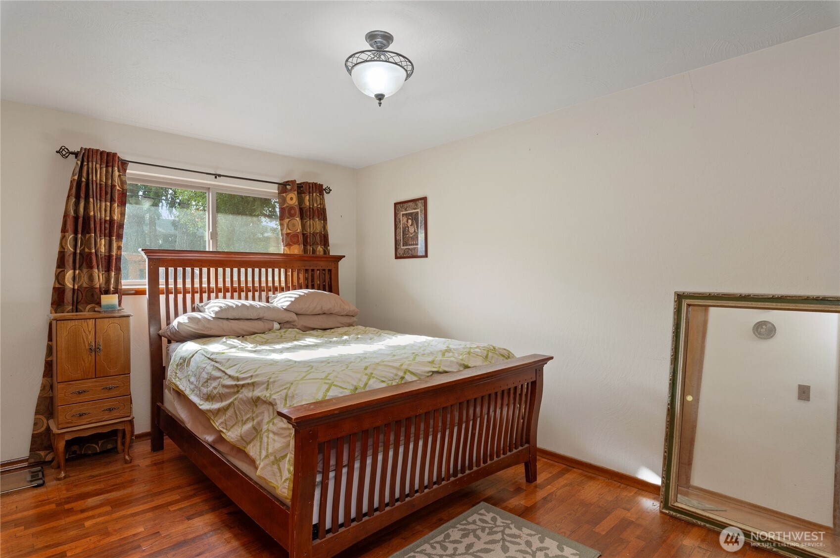 9101 112th Street Southwest Lakewood, WA 98498 - Photo 2 of 27 a bedroom with a bed and wooden floor