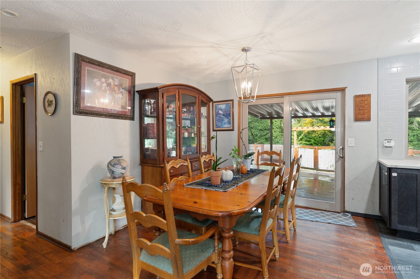 9101 112th Street Southwest Lakewood, WA 98498 - Photo 9 of 27 a view of a dining room with furniture a chandelier and wooden floor