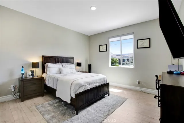 a bed room with a bed tv and a window