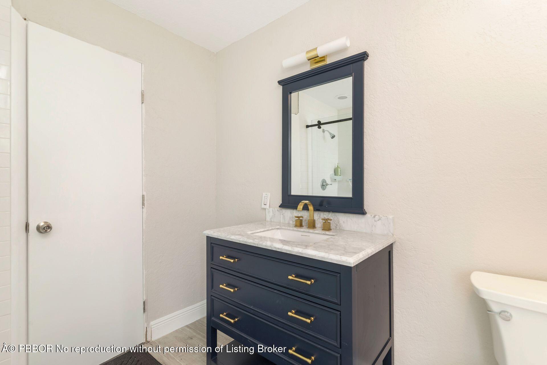 2770 E Road Loxahatchee, FL 33470 - Photo 24 of 51 a bathroom with a sink vanity and a mirror