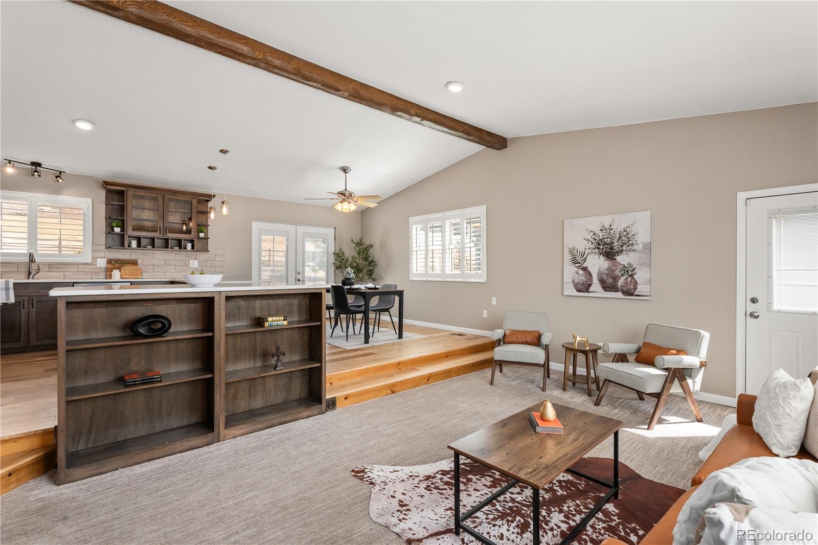 3920 Collins Street Castle Rock, CO 80108 - Photo 13 of 40 a living room with couches and kitchen view with wooden floor