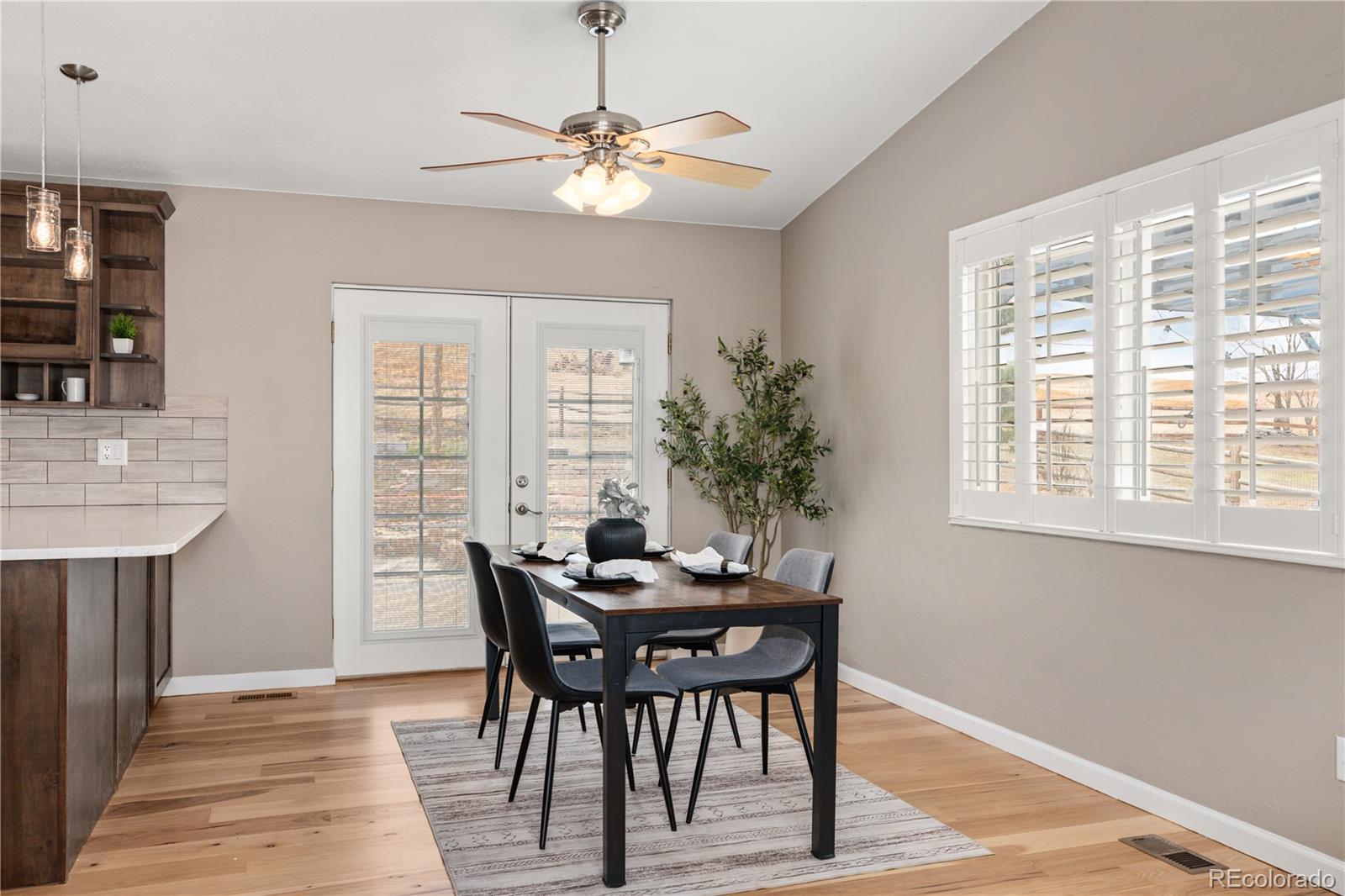3920 Collins Street Castle Rock, CO 80108 - Photo 14 of 40 a view of a dining room with furniture window and wooden floor