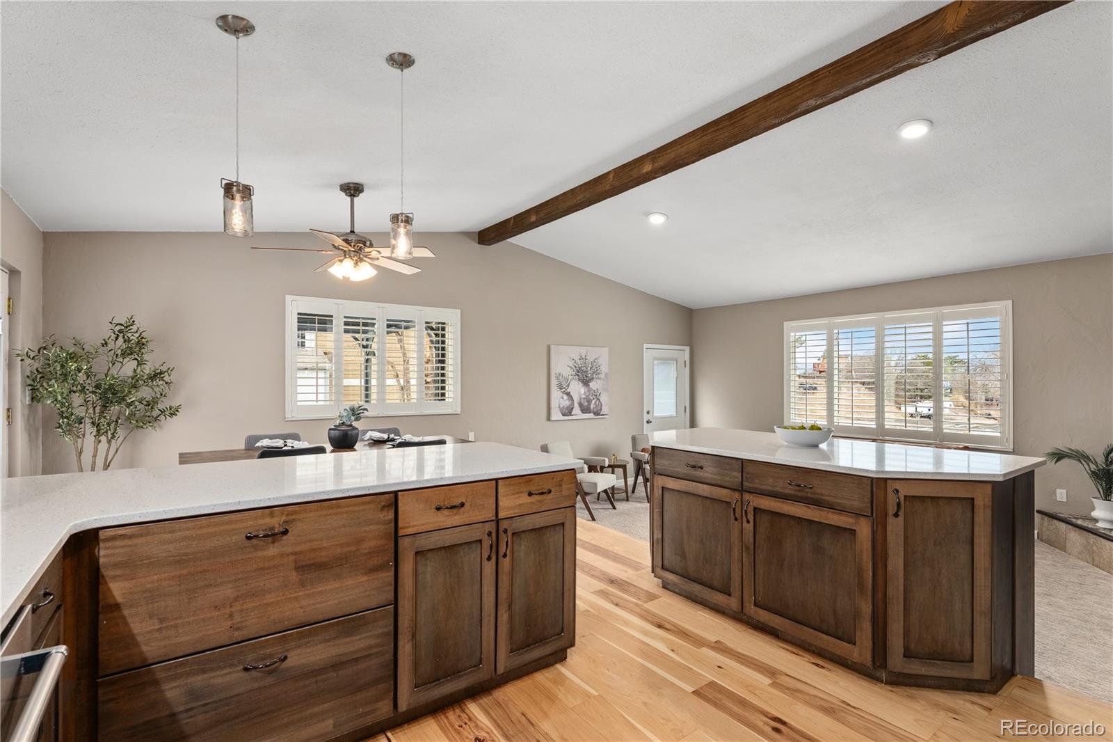 3920 Collins Street Castle Rock, CO 80108 - Photo 16 of 40 a large kitchen with kitchen island a sink stainless steel appliances and cabinets