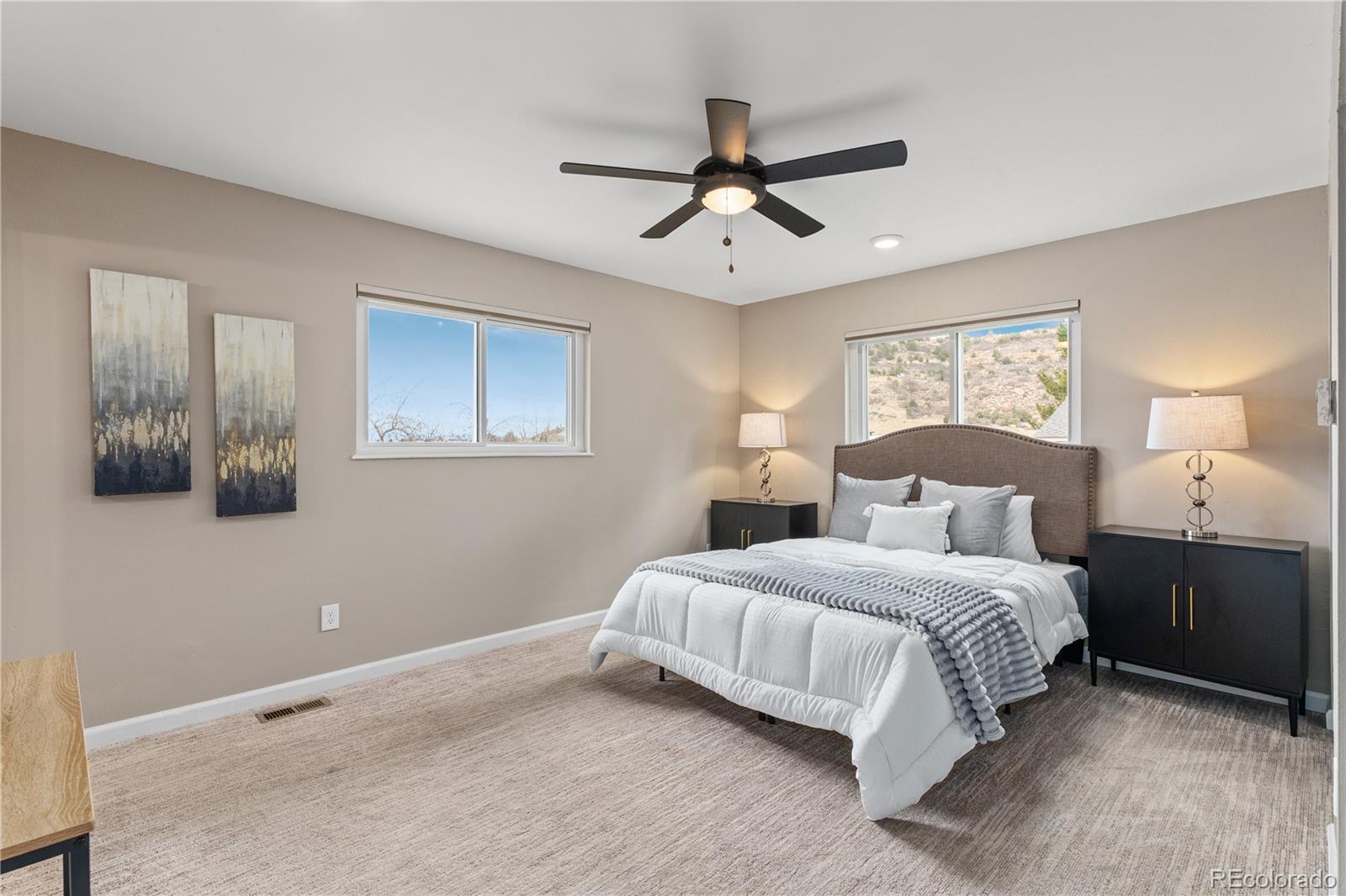 3920 Collins Street Castle Rock, CO 80108 - Photo 19 of 40 a bedroom with a large bed and a window
