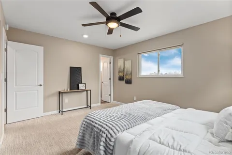 a bedroom with a bed and a tv