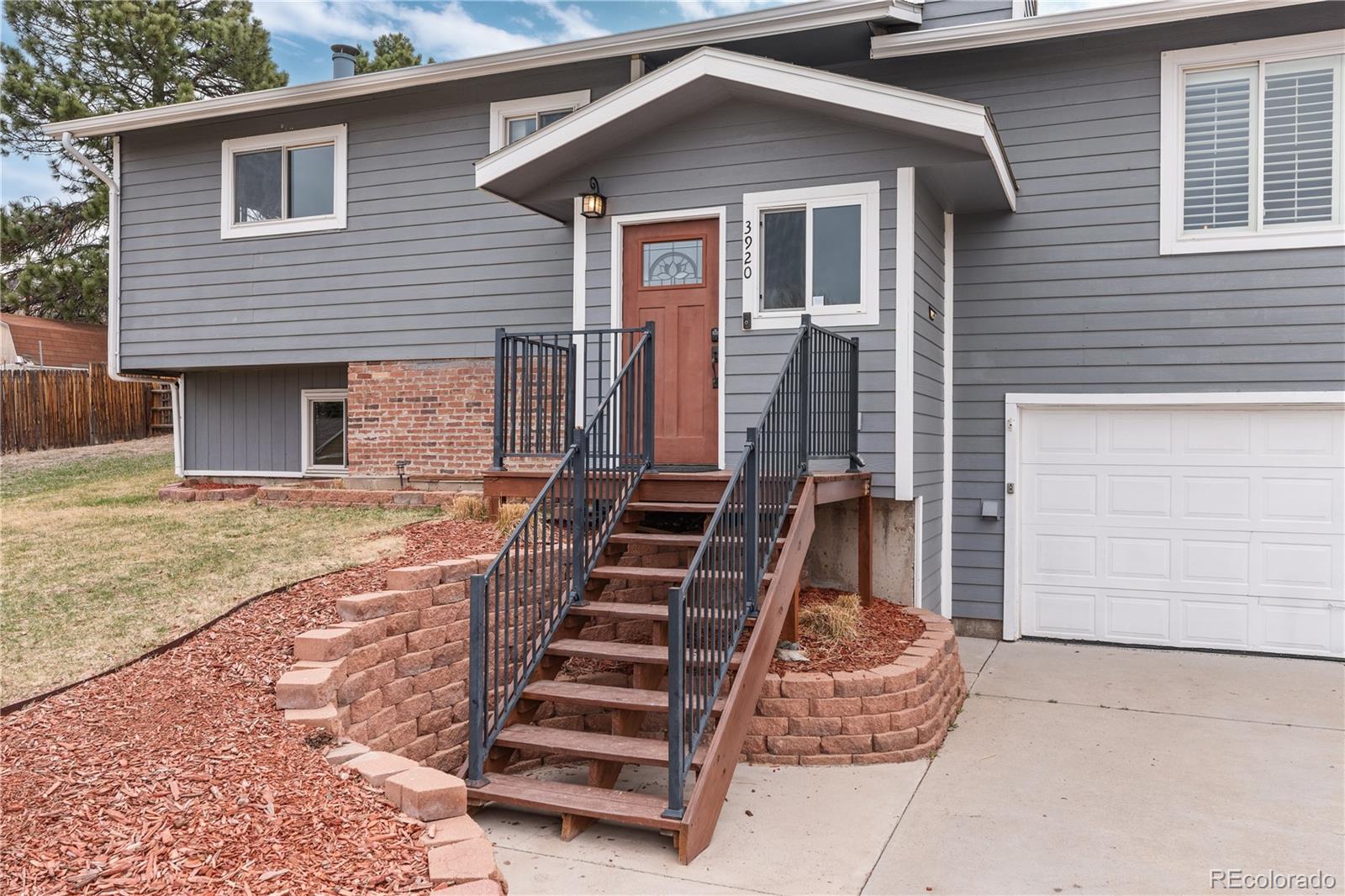 3920 Collins Street Castle Rock, CO 80108 - Photo 2 of 40 a front view of a house with stairs