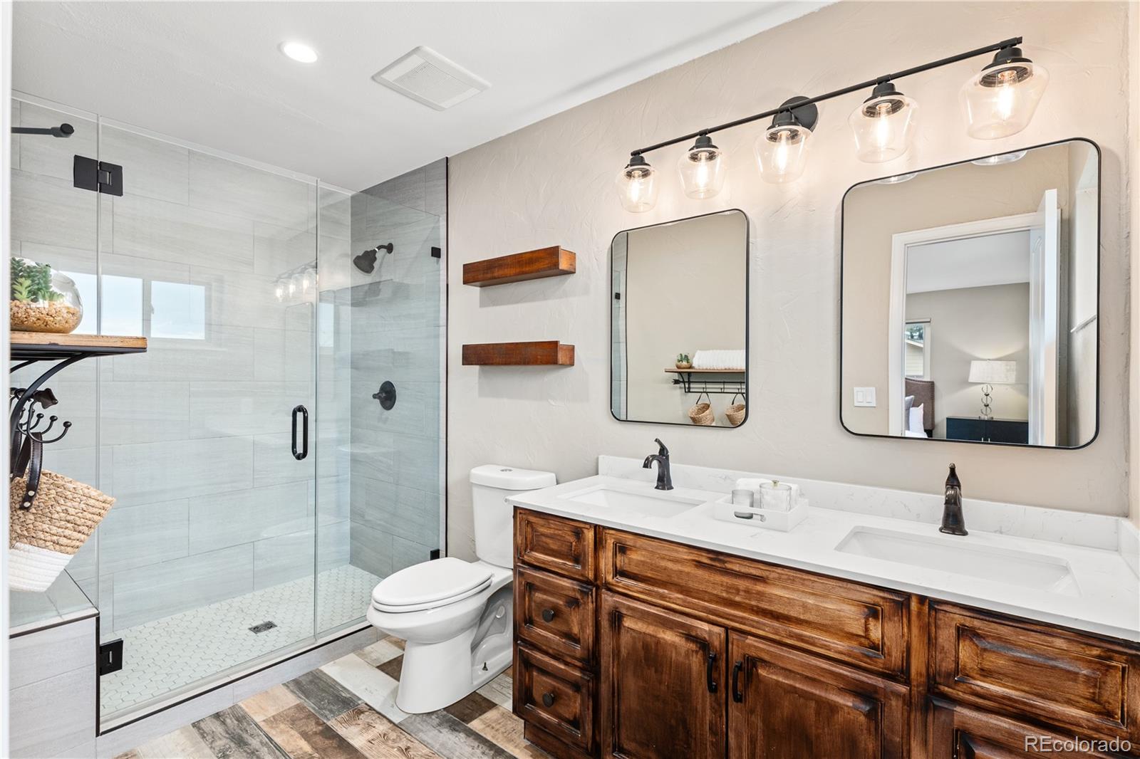 3920 Collins Street Castle Rock, CO 80108 - Photo 22 of 40 a bathroom with a granite countertop sink toilet and shower