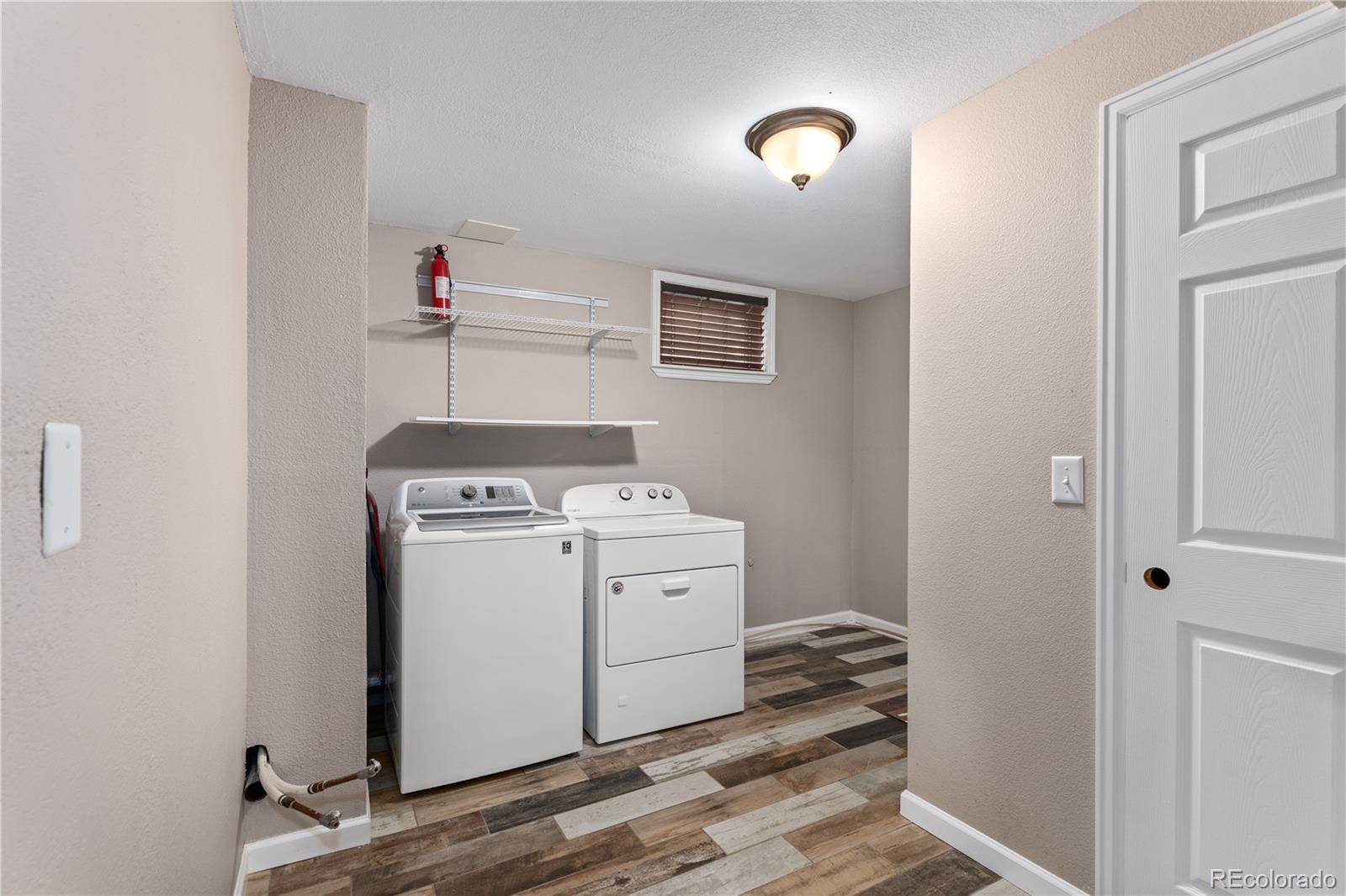 3920 Collins Street Castle Rock, CO 80108 - Photo 27 of 40 a view of a storage & utility room with washer and dryer