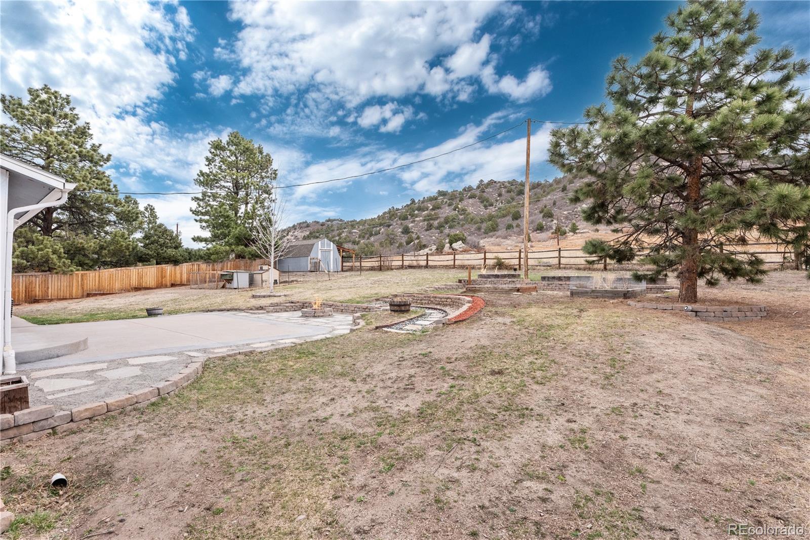 3920 Collins Street Castle Rock, CO 80108 - Photo 34 of 40 a view of dirt yard with a large tree