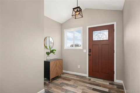 a view of an entryway with wooden floor