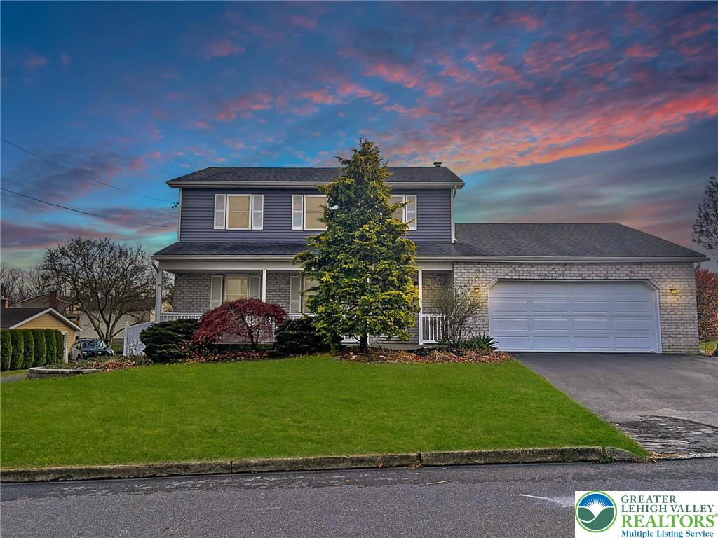 a front view of a house with a garden and plants