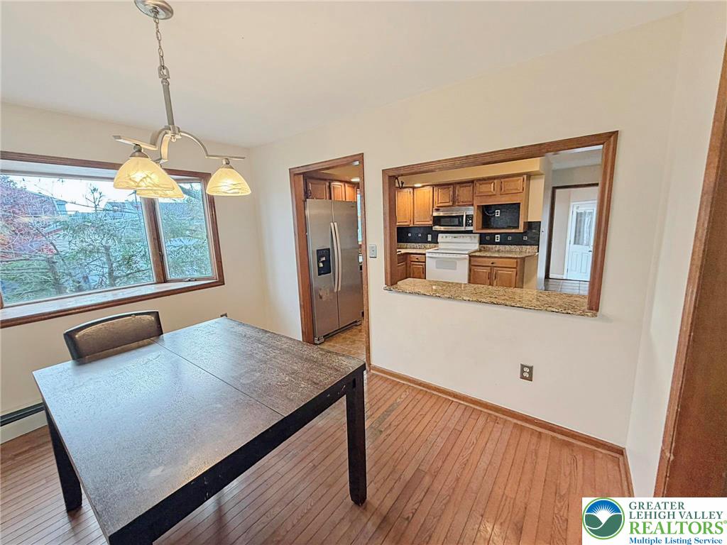 719 Hunter Street Catasauqua, PA 18032 - Photo 12 of 41 a living room with kitchen island furniture and a wooden floor