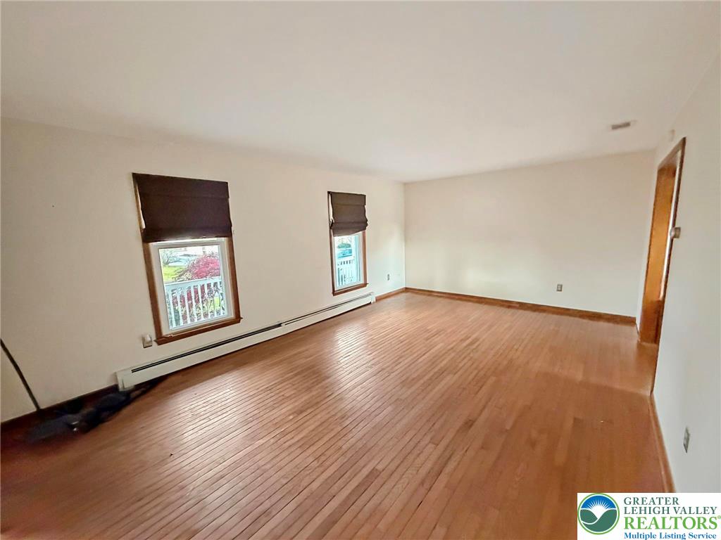 719 Hunter Street Catasauqua, PA 18032 - Photo 14 of 41 an empty room with wooden floor and windows