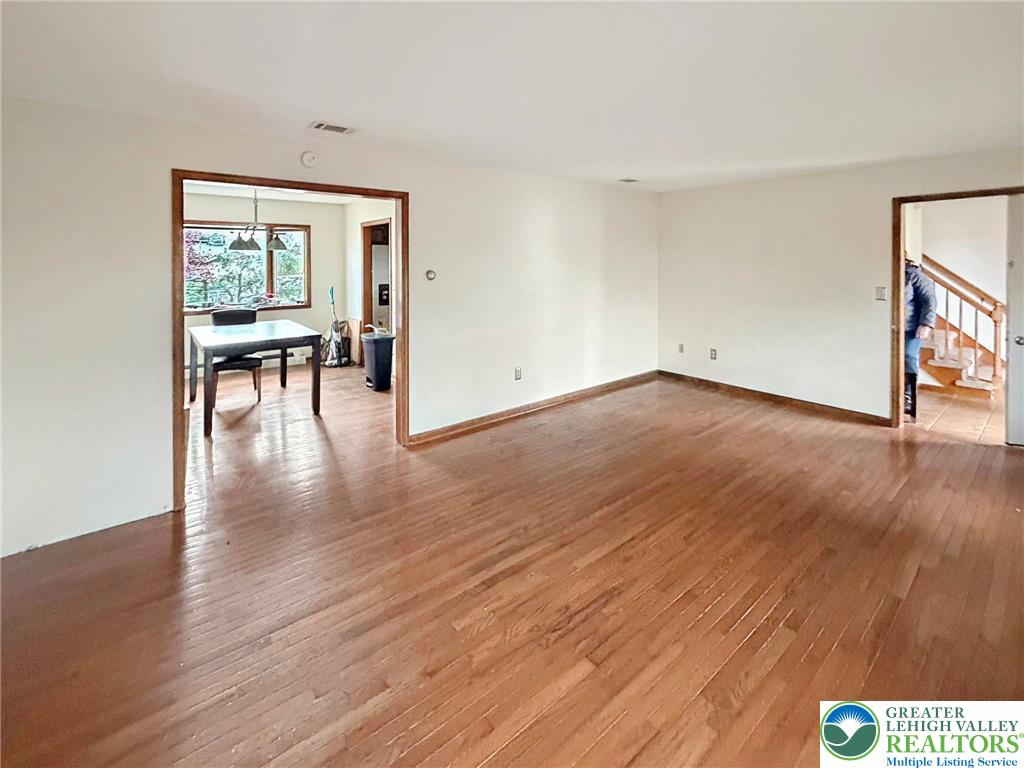 719 Hunter Street Catasauqua, PA 18032 - Photo 16 of 41 a view of empty room with wooden floor and fan
